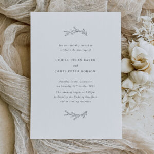 Delight - simple minimal wedding stationery with leaf motif shown on ivory fabric background