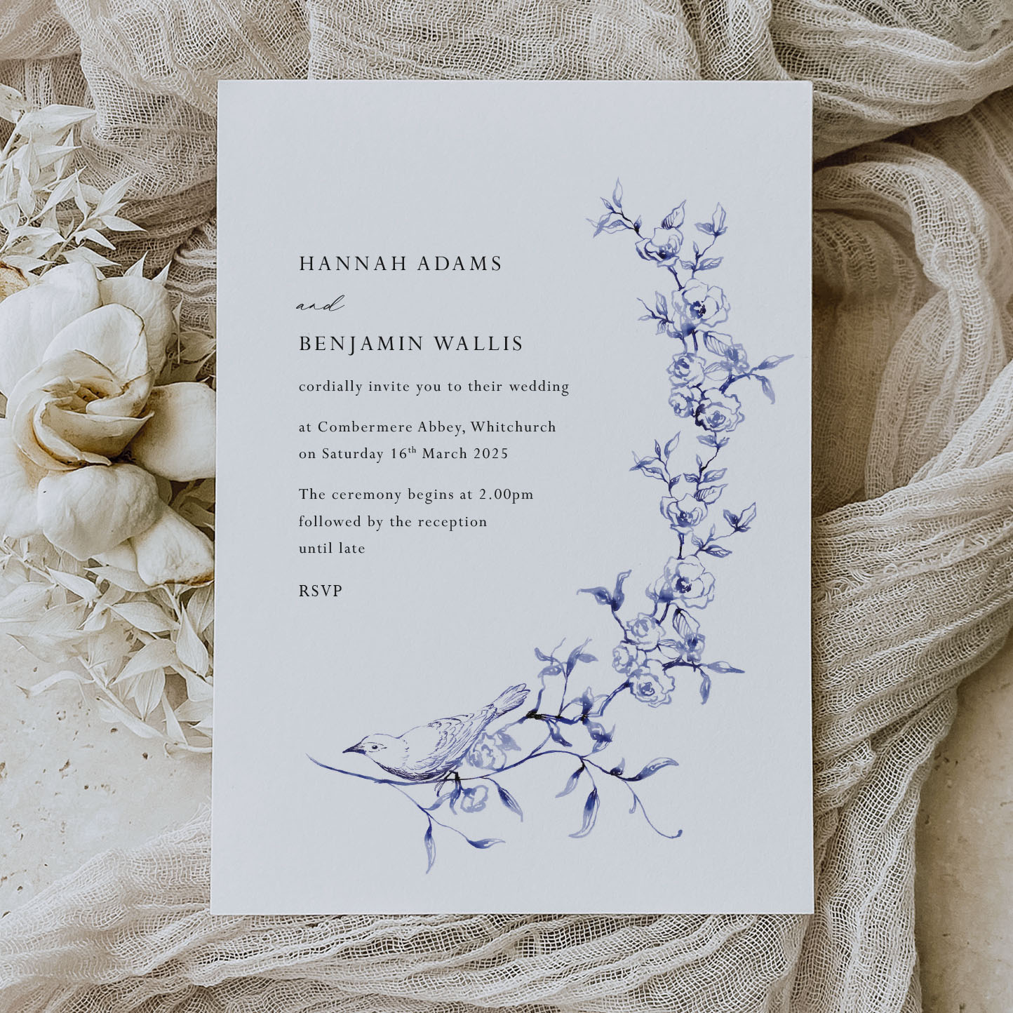 showing Garden Bird - Romantic wedding stationery design it has a blue bird and cascading flower illustration on a white card background