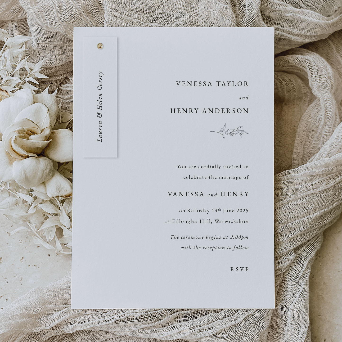 Laurel Leaf - simple modern wedding stationery with leaf motif shown on cream fabric background with a pin holding the guest names on the invitation