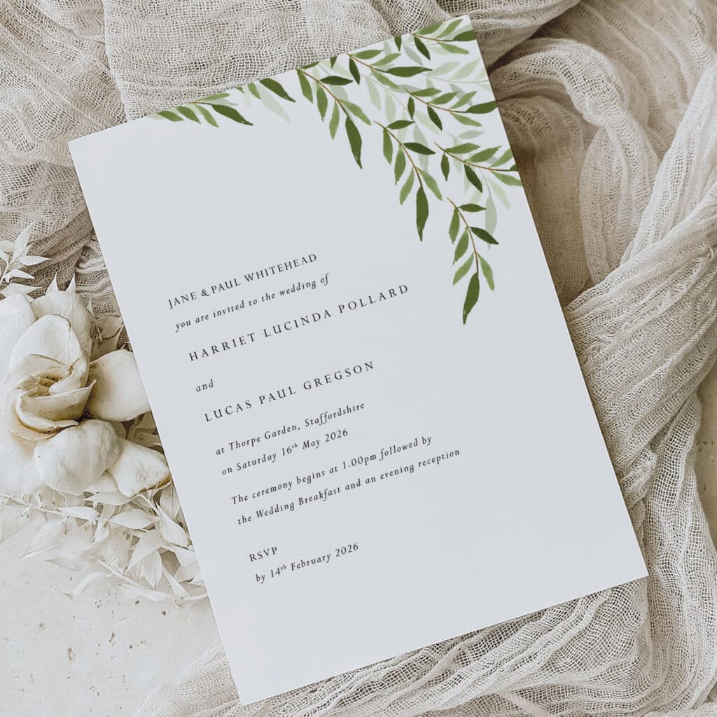 simple botanical leafy wedding invitation design on white card