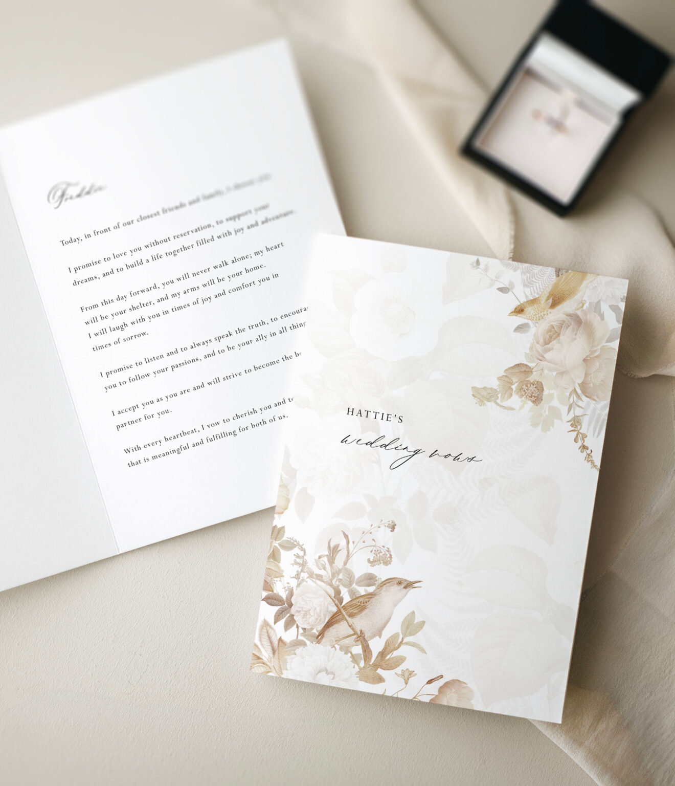 vintage styled wedding vow book on cream background with ring box
